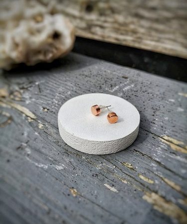 stud earrings displayed on a piece of wood - copper stud earrings