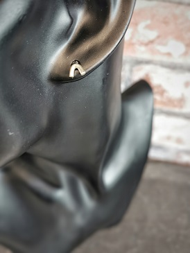 stud earring on black plastic manikin - minimal stud earrings