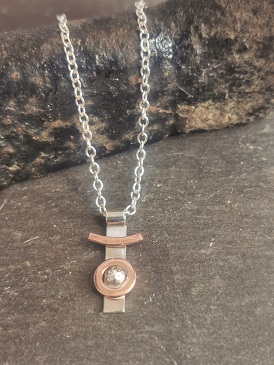 necklace displaced over a coblers last- sterling silver and copper necklace