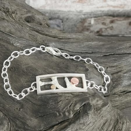 bracelet displayed on bog oak - handmade sun and moon sterling silver bracelet