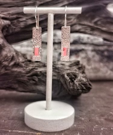 earrings on display stand infront of bog aok - handmade geometric earrings