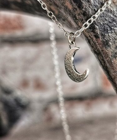 necklace hanging from a cobblers last - sterling silver moon necklace