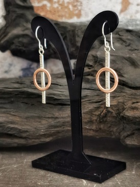 earrings displayed on a stand infront of bog oak - sterling silver and copper g