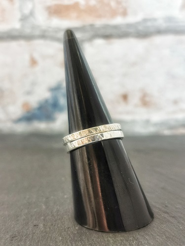 rings displayed on plastic cone - layered textured sterling silver rings