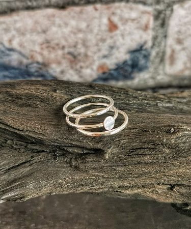 rings displayed on bog oak - minimal stacking sterling silver rings