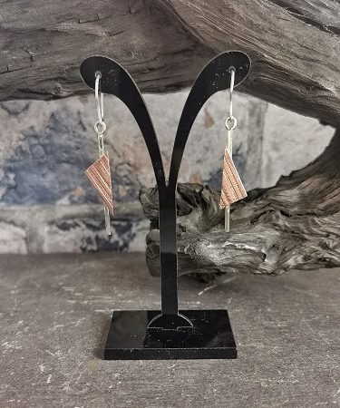 earrings on a display stand in front of bog oak - funky triangle