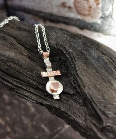 necklace displayed on bog oak - handmade geometric necklace